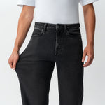 Close-up showing the stretch of the denim on the Wide Flextech™ Jeans in faded black