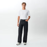 Styled full-body front view of the Wide Flextech™ Jeans in faded black