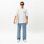 Styled full-body front view of the Wide Flextech™ Jeans in light blue