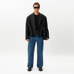 Styled full-body front view of the Wide Flextech™ Jeans in mid blue