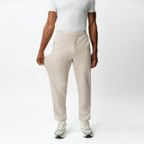 Full-body view showing the stretch of the beige Socrates Classic straight-leg pant fabric
