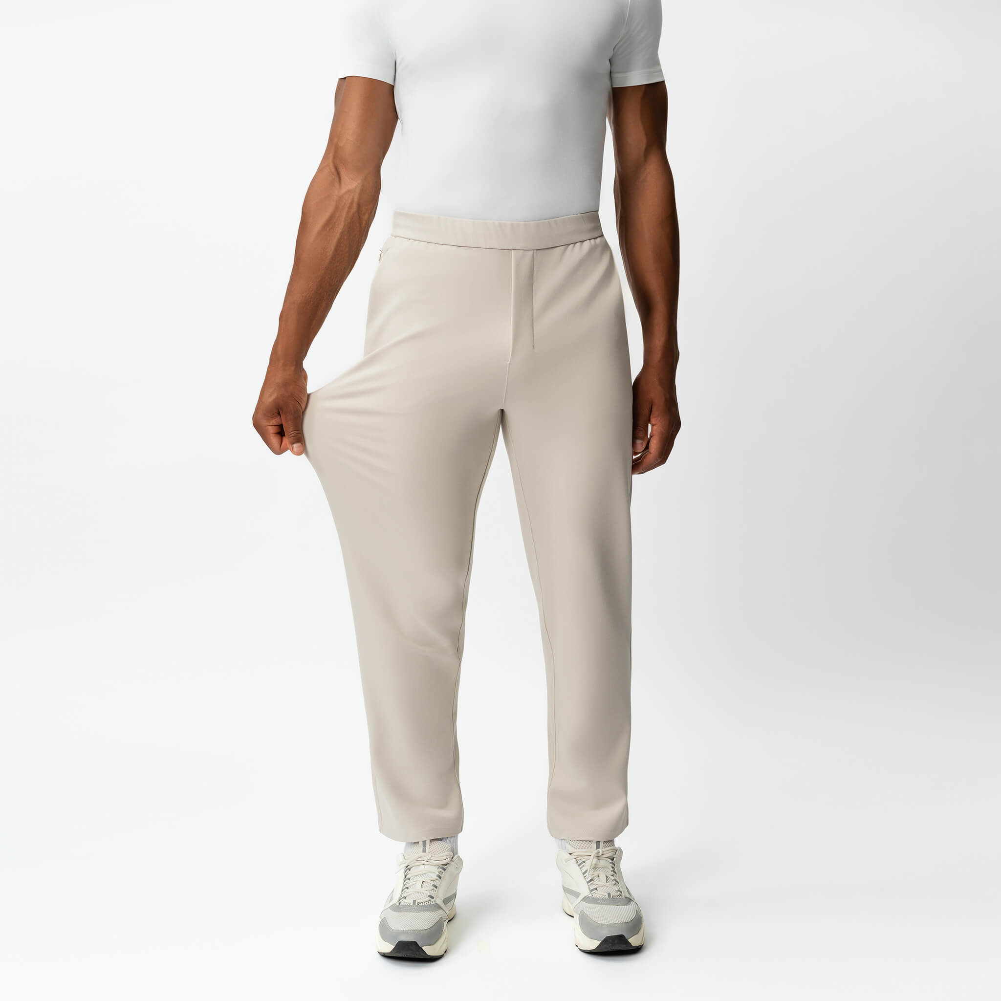 Full-body view showing the stretch of the beige Socrates Classic straight-leg pant fabric
