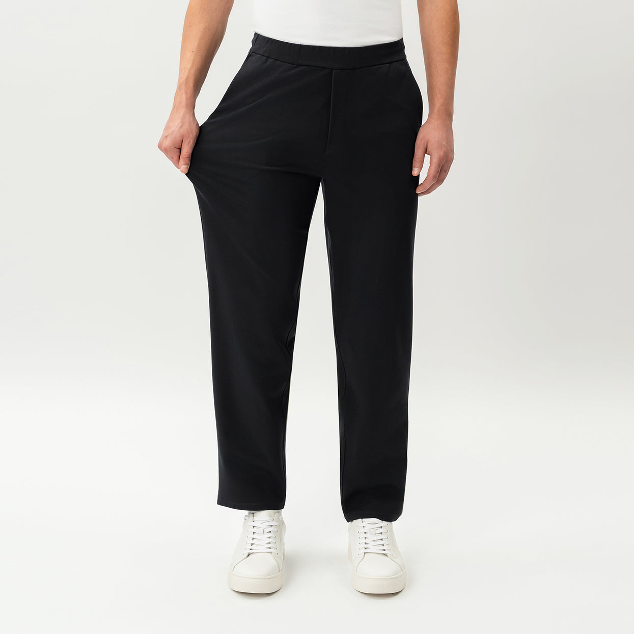 Detail showing the stretch of the black Socrates Classic straight-leg pant fabric at the waistband
