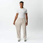 Full-body view showing the stretch of the beige Socrates wide-leg pant fabric