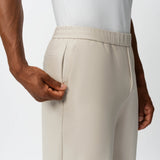 Detail of elasticated waistband and pocket on the beige Socrates Pant
