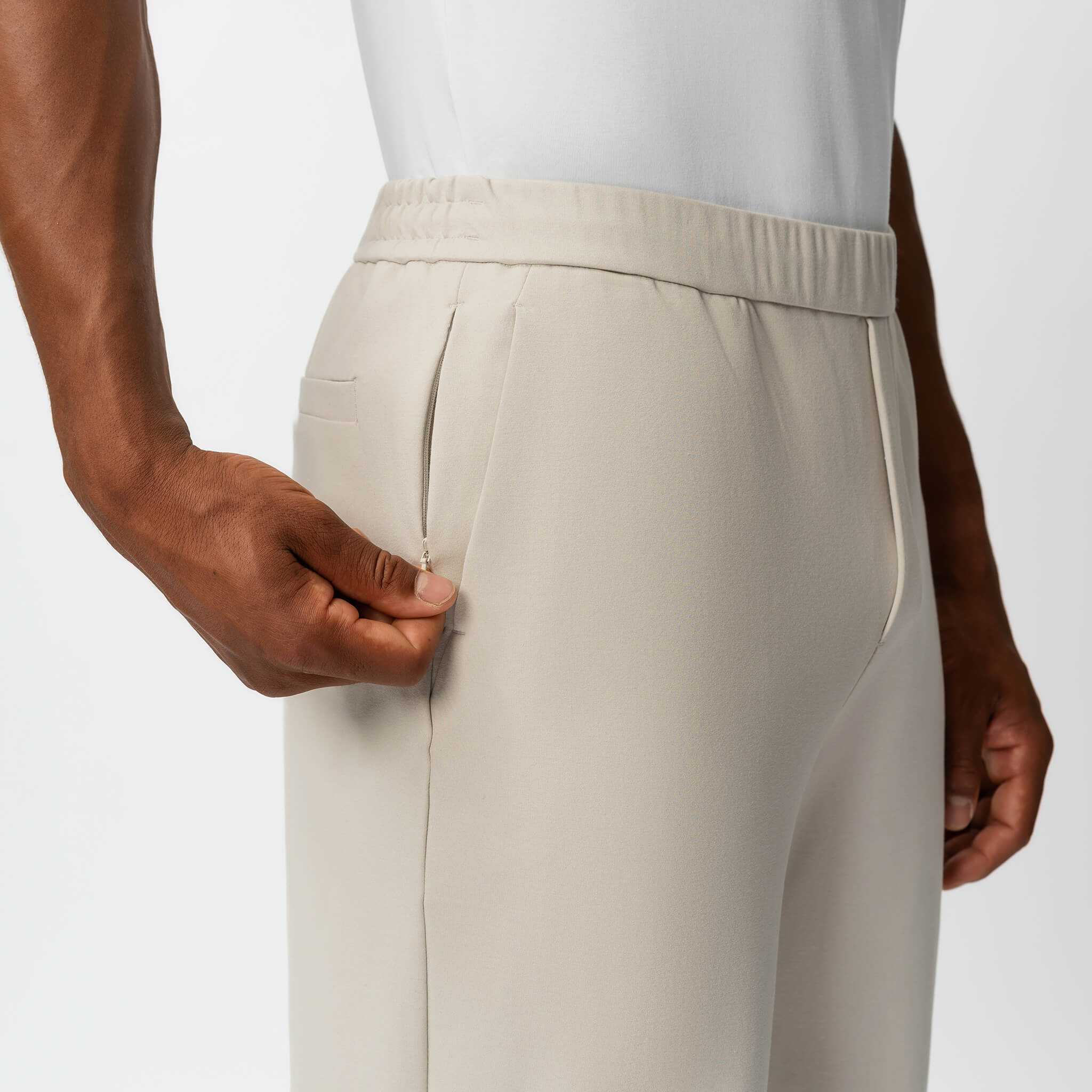 Detail of elasticated waistband and pocket on the beige Socrates Pant