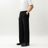 Side view of the Socrates wide-leg pant in black showing relaxed leg shape
