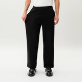 Detail showing the stretch of the black Socrates wide-leg pant fabric