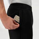 Detail of elasticated waistband and pocket on the black Socrates Pant