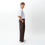 Side view of the Socrates wide-leg pant in brown showing relaxed leg shape