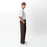 Side view of the Socrates wide-leg pant in brown showing relaxed leg shape