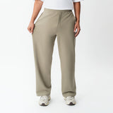 Full-body view showing the stretch of the khaki Socrates wide-leg pant fabric
