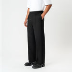 Angled front view of the black Socrates wide-leg pleated pant