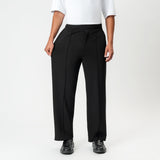 Full-body view showing the stretch of the black Socrates wide-leg pleated pant fabric