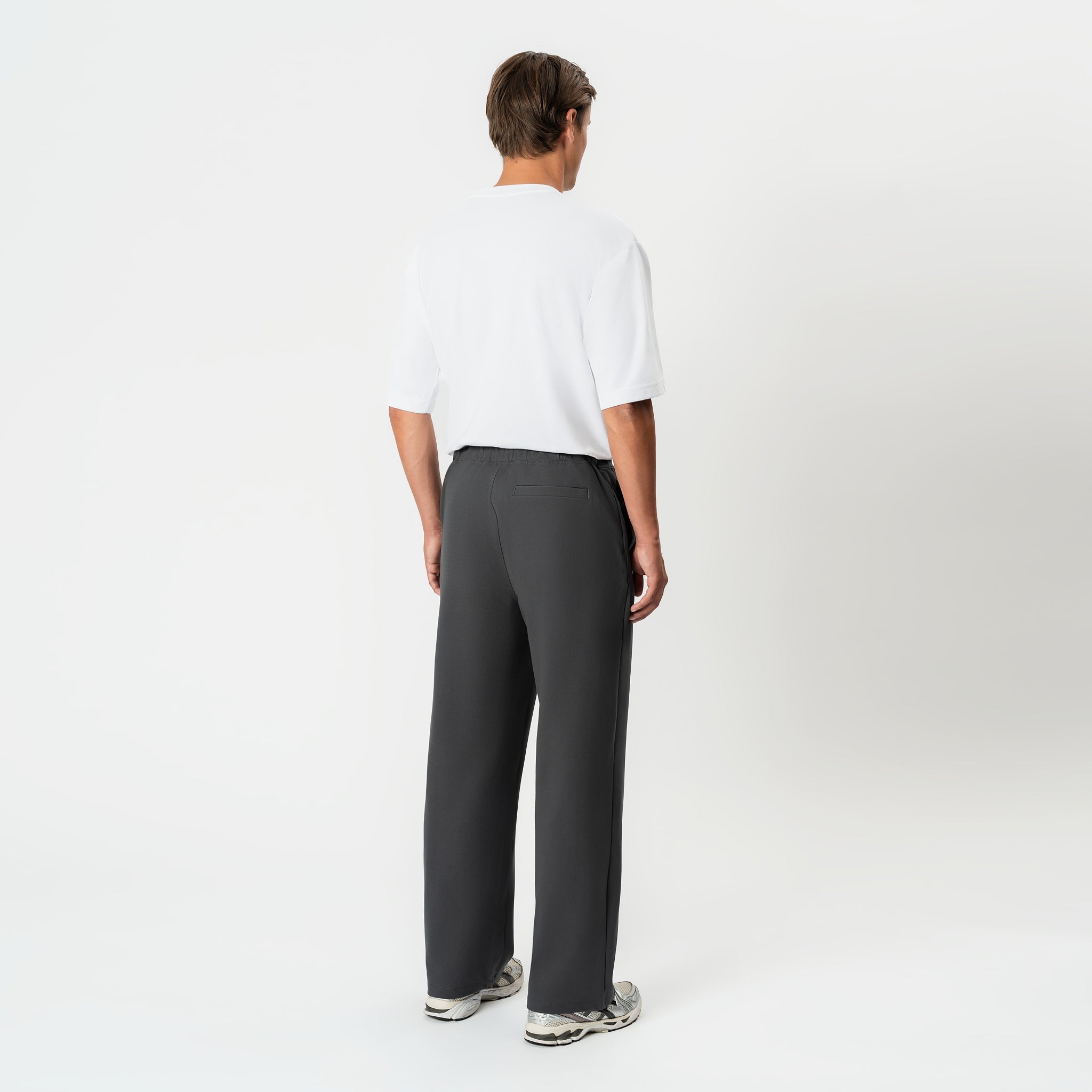 Angled back view of the grey Socrates wide-leg pleated pant