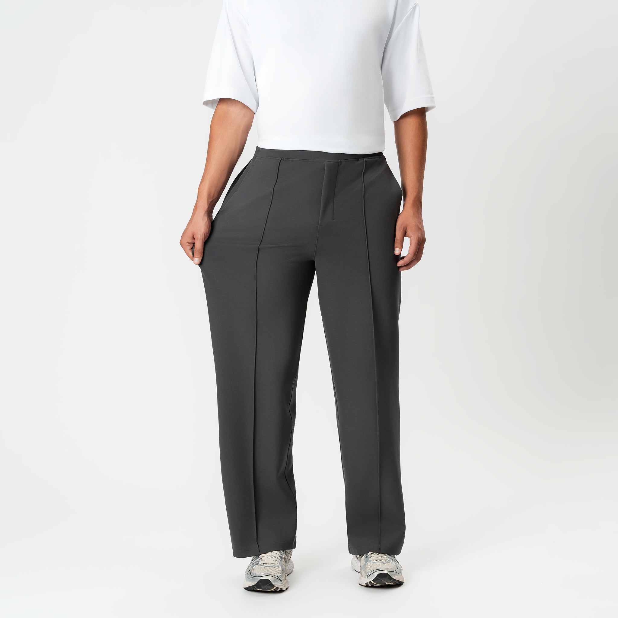 Full-body view showing the stretch of the grey Socrates wide-leg pleated pant fabric
